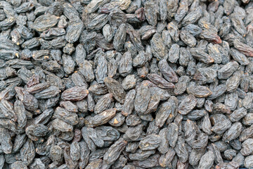 Black raisins for the backdrop. Dried sweet grapes.