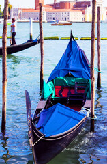 Fototapeta na wymiar Traditional gondola moored in St. Mark's Square in the Grand Canal in Venice, Italy. Famous Italian landmark and Venetian symbol. Soft focus