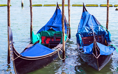Fototapeta na wymiar Traditional gondola moored in St. Mark's Square in the Grand Canal in Venice, Italy. Famous Italian landmark and Venetian symbol. Soft focus