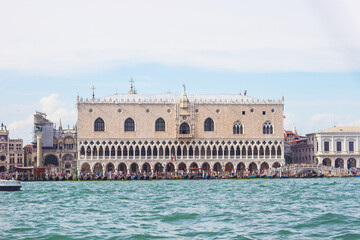 Fototapeta na wymiar Famous Doge's palace on Piazza di San Marco, view from the the Grand Canal in Venice, Italy. Italian buildings cityscape. Famous romantic city on water