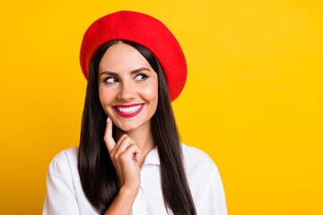 Portrait of charming young girl finger on chin look interested empty space isolated on yellow color background