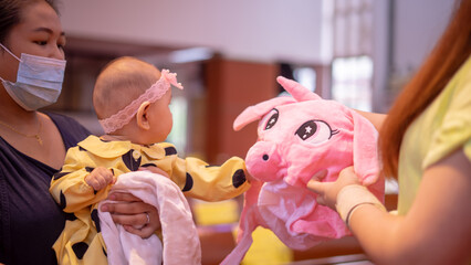 Baby Asian Girl Playing with Stuffed Animal Hat