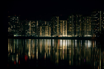 skyscrapers are reflected in the river at night cityscape