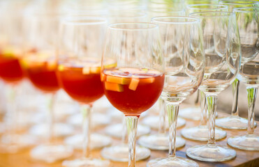 cocktail bowls ,some with red drink and fruits and some empty