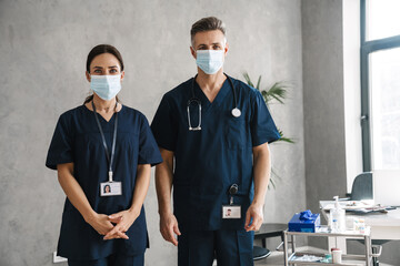 Fototapeta na wymiar Two confident doctors in medical masks standing