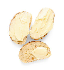 Slices of fresh bread with butter on white background