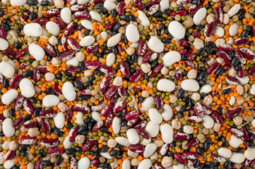 Mix of legumes, chickpeas, lentils and beans on a gray concrete background. Top view. Copy space.