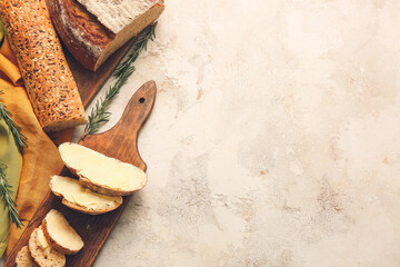 Fresh bread with butter and rosemary on light background - obrazy, fototapety, plakaty