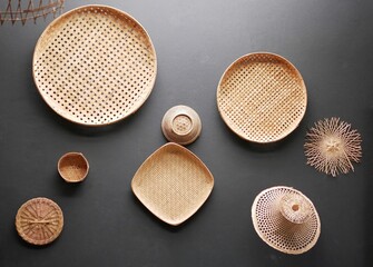 Wall decoration with old weave bamboo trays and bamboo hats, handmade products in Thailand.