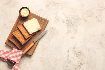Board with slices of fresh bread and butter on light background