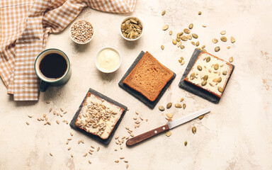 Composition with fresh bread, butter and seeds on light background