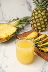 Fototapeta na wymiar Glass of fresh pineapple juice on white background