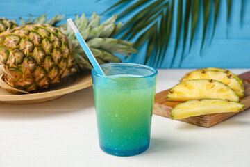 Fototapeta na wymiar Glass of fresh pineapple juice on table