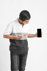 Young indian college student showing smartphone screen on white background.