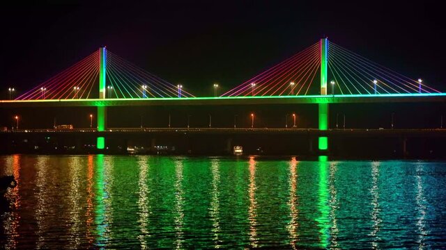 Mandovi River Bridge in moonlight, with the reflection of colored lights in the river. also known as Atal Setu.