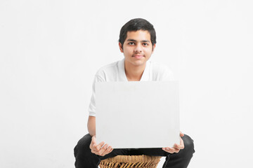 Young indian college student showing white board on white background