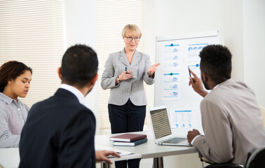 Fototapeta premium Senior business woman with young colleagues at office