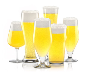 Set of fresh light beer glasses with bubble froth isolated on white background.