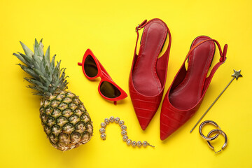 Pineapple with female accessories on color background