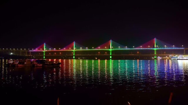 Mandovi River Bridge in moonlight, with the reflection of colored lights in the river. also known as Atal Setu.
