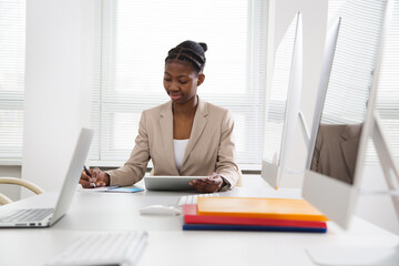 Portrait of african american business woman looking at camera at workplace in an office
