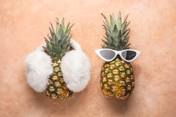 Pineapples with female accessories on color background