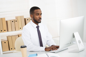 Young african american businessman working alone in the office