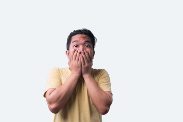 Face reaction, Asian young man portrait of face expression, shocked, thrilled, scared, surprised, with covered face with hand. Isolated, selective focus, copy space