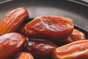 Plate with sweet dried dates, closeup