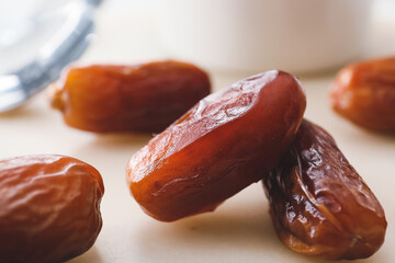 Sweet dried dates on light background, closeup