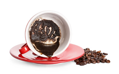 Cup with spent coffee grounds for fortune telling on white background