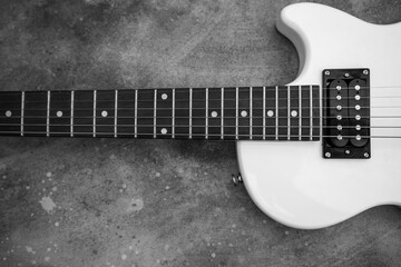 Fototapeta na wymiar Beautiful vintage white electric guitar shape on a grey background in black and white. High quality photo