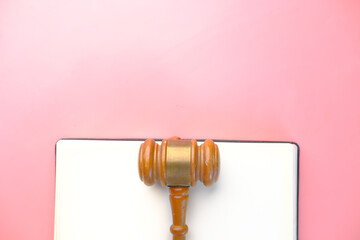  gavel and book with copy space on pink background 