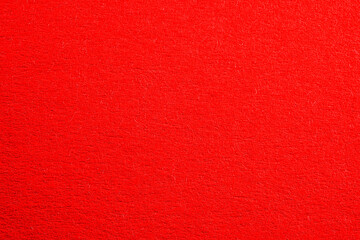 Red colored paper with strong structure as a background, photographed in the studio