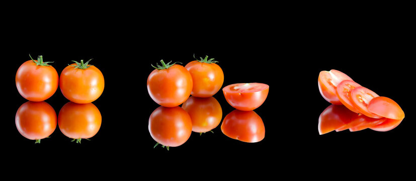 A line of beautiful, red and natural tomatoes and tomato slices put in a horizontal line, all of the tomatoes are being reflected on the black background