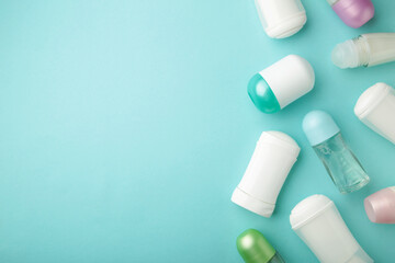 Different deodorants on blue background with copy space, top view. Skin care
