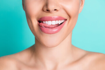 Cropped photo of young cheerful lovely smiling showing tongue and perfect teeth isolated on teal color background