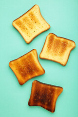 Slices of toast bread on mint background