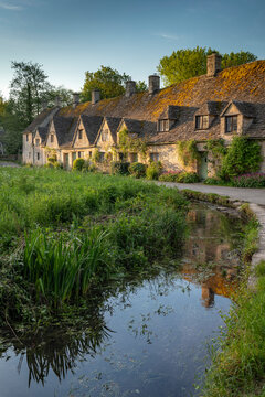 Early Spring morning view of the beautiful Cotswolds cottages at Arlington Row in Bibury, Gloucestershire, England, United Kingdom