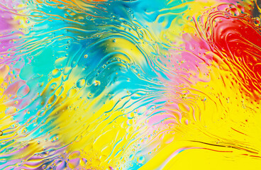 Fototapeta na wymiar oil drops on water with vivid colorful background