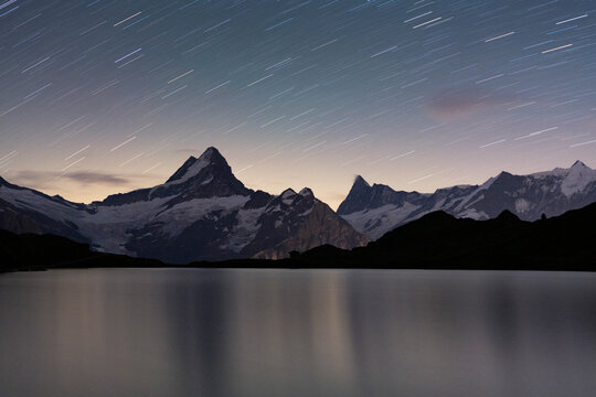 Star trail in the night sky over Bachalpsee lake, Grindelwald, Bernese Oberland, Canton of Bern, Switzerland