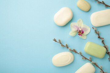 Different white soaps with flowers. A lot of solid soap for hygiene and cleanliness on a blue background.