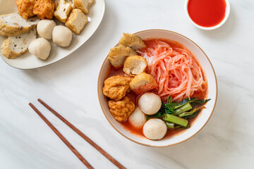 small flat rice noodles with fish balls and shrimp balls in pink soup, Yen Ta Four or Yen Ta Fo