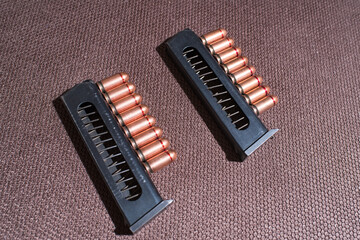 Copper firearms bullets and pistol clips. Weapon