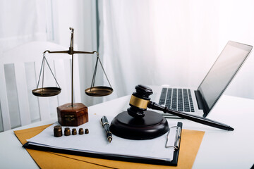 Justice and law concept.Male judge in a courtroom with the gavel, working with, computer and...