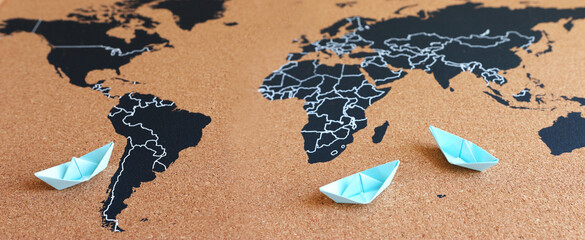 concept of tansportation and logistics. paper boats and worlwide banner
