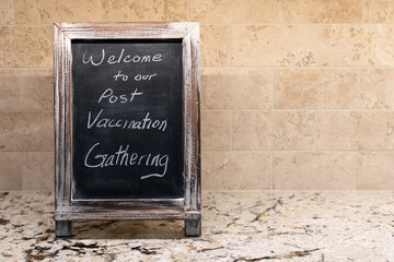 Sign at a small party celebrating the end of COVID social distancing. The US CDC has stated that we may visit with other fully vaccinated people indoors without wearing masks or staying 6 feet apart.