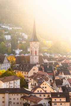 Sunlight illuminates the old town of Chur, Canton Graubunden, Switzerland