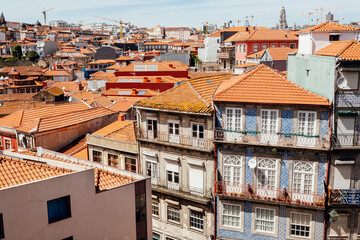 Fototapeta na wymiar Historical houses and narrow streets of the city with colorful walls and rustic textures. Porto.