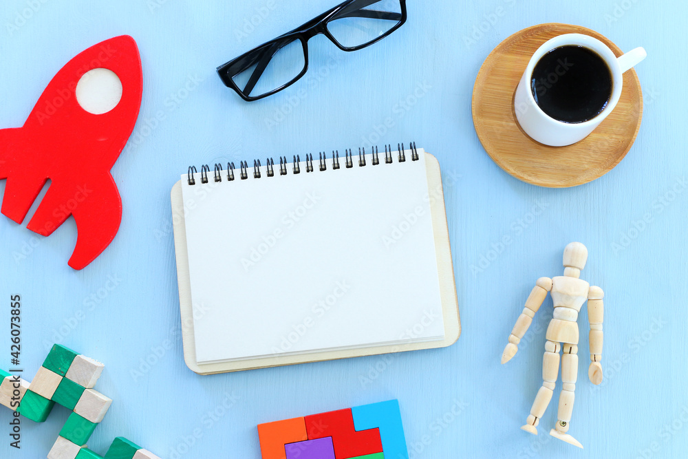 Fototapete top view image of open notebook with blank pages next to cup of coffee on wooden table. ready for ad